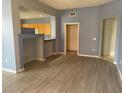 Open-concept living area featuring wood-style flooring and neutral paint at 15 E Agate Ave # 202, Las Vegas, NV 89123