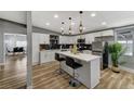 Bright kitchen featuring white cabinets, quartz countertops, a black backsplash, and stainless steel appliances at 1660 Izabella Ave, Las Vegas, NV 89169