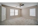 Bright bedroom features neutral walls, plush carpet, and two sunny windows with blinds at 189 Kings Canyon Court Ct, Henderson, NV 89012