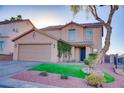Charming two-story home featuring a well-manicured lawn, desert landscaping, and an attached two-car garage at 189 Kings Canyon Court Ct, Henderson, NV 89012