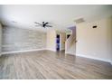 Spacious living room features wood floors, decorative wall, and ceiling fan at 189 Kings Canyon Court Ct, Henderson, NV 89012