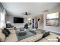 Bright living room with modern furnishings, a large TV, and a decorative accent wall at 189 Kings Canyon Court Ct, Henderson, NV 89012