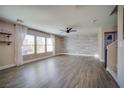 Spacious living room with modern flooring, accent wall, and natural light from large windows at 189 Kings Canyon Court Ct, Henderson, NV 89012