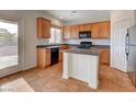 Bright kitchen features granite countertops, island, and stainless steel appliances at 209 Tainted Berry Ave, North Las Vegas, NV 89031