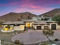 Stunning home featuring meticulous landscaping, a three-car garage, and a sprawling driveway at 211 Granite Ct, Boulder City, NV 89005