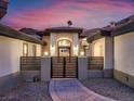 Elegant front entry showcases a well-lit walkway, decorative gate, and manicured landscaping at 211 Granite Ct, Boulder City, NV 89005