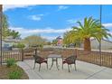 A pleasant outdoor seating area with table and chairs, offering a view of a desert-landscaped neighborhood at 2429 Wisconsin Dells Dr, Henderson, NV 89044