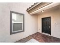Inviting front entrance with tile flooring and stylish black front door at 2482 Denholme St, Henderson, NV 89044