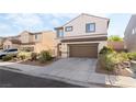 Charming two-story home featuring desert landscaping and a two-car garage at 2482 Denholme St, Henderson, NV 89044