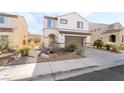 Charming two-story home featuring desert landscaping and a two-car garage at 2482 Denholme St, Henderson, NV 89044