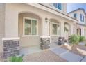 Charming home entryway with stone pillar accents and manicured landscaping at 25 Barbara Ln # 57, Las Vegas, NV 89183