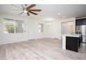 Bright, open-concept living area with new hard surface floors and ceiling fan at 25 Barbara Ln # 57, Las Vegas, NV 89183