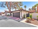 Charming home featuring a two-car garage, red tile roof, and desert landscaping at 2583 Egret Cir, Las Vegas, NV 89121
