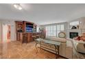 Bright living area boasts tile floors, modern decor, a fireplace, and a custom bar for seamless entertaining at 2747 Paradise Rd # 501, Las Vegas, NV 89109