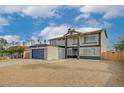 Two-story home featuring a large garage, desert landscaping, and a secure fenced yard at 2839 Boise St, Las Vegas, NV 89121