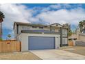 Two-story home featuring a large garage, desert landscaping, and a secure fenced yard at 2839 Boise St, Las Vegas, NV 89121
