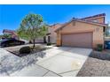 Lovely single-Gathering home with a two-car garage, desert landscaping and a well-maintained lawn at 3193 Emerald Creek Dr, Las Vegas, NV 89156