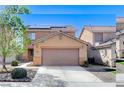 Two-story single-Gathering home with a two-car garage, solar panels, and low maintenance desert landscaping at 3193 Emerald Creek Dr, Las Vegas, NV 89156