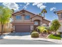 Charming two-story home with a two-car garage and mature palm tree in the front yard at 3800 Crema Ct, Las Vegas, NV 89129