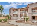 Condominium exterior featuring multiple levels, desert landscaping, and common stairwells accessing the units at 5170 S Jones Blvd # 205, Las Vegas, NV 89118