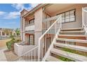 Condominium exterior showing entry stairs to upper units, desert landscaping and building facade at 5170 S Jones Blvd # 205, Las Vegas, NV 89118