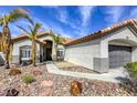 Beautiful desert landscaping, stucco exterior, and walkway to the front door of this single-Gathering home at 5437 Escallonia St, Las Vegas, NV 89149