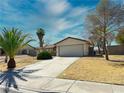 Exterior view of a single-story home with desert landscaping and a two-car garage at 6397 Kell Ln, Las Vegas, NV 89156