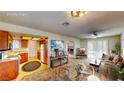Open-concept living space with kitchen access and sliding glass doors to the exterior at 6397 Kell Ln, Las Vegas, NV 89156
