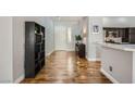 Inviting entryway with wood floors leading to the kitchen with sleek countertop at 64 Chateau Whistler Ct, Las Vegas, NV 89148