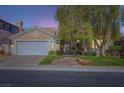 Charming single-story home featuring a well-maintained front yard and a two-car garage at 64 Chateau Whistler Ct, Las Vegas, NV 89148