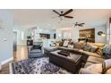 Spacious living room featuring wood floors, comfortable seating, and an open layout at 64 Chateau Whistler Ct, Las Vegas, NV 89148