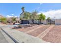 Lovely two-story home with a landscaped front yard and an extended driveway for extra parking at 6401 Goldmine Dr, Las Vegas, NV 89156