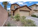 Two-story home with a two-car garage, desert landscaping and a beautiful walkway at 651 Penshaw Bridge Ave, Las Vegas, NV 89178