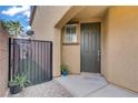 Inviting front entrance featuring a dark-colored door and a small, gated yard at 651 Penshaw Bridge Ave, Las Vegas, NV 89178