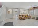 Expansive living room showcasing tile flooring, an open floor plan, and abundant natural light at 651 Penshaw Bridge Ave, Las Vegas, NV 89178