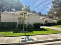 Lovely home exterior featuring manicured landscaping, a red tile roof, and a freshly cut lawn at 6987 Emerald Springs Ln, Las Vegas, NV 89113