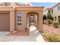 Inviting front entrance with an arched entryway and a well-maintained walkway at 7905 Coral Point Ave, Las Vegas, NV 89128