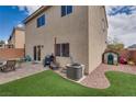 Private backyard featuring a well-kept yard, a patio perfect for outdoor entertainment, and a grassy area at 7919 Mineral Peak St, Las Vegas, NV 89166