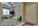 Inviting entryway featuring a colorful rug, modern seating and a ceiling fan for added comfort at 7919 Mineral Peak St, Las Vegas, NV 89166