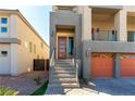 This is a close up of the modern front entry of the home with a glass paneled door and light brown trim at 8179 Shale Canyon St, Las Vegas, NV 89139