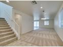 Spacious living room with carpeted floors, recessed lighting, ceiling fan and sliding glass door to backyard at 844 Aurelie Ridge St, Henderson, NV 89011