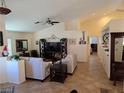 Spacious living room with tile flooring, vaulted ceilings, and neutral-toned walls at 853 Rusty Anchor Way, Henderson, NV 89002
