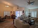 Bright living room with tile floors, plantation shutters, and ample seating at 853 Rusty Anchor Way, Henderson, NV 89002