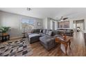 Open-concept living room with wood floors, large windows, and modern décor at 9121 Ripple Ridge Ave # 101, Las Vegas, NV 89149