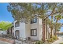 Exterior view of the condo building with mature trees and landscaping at 950 Seven Hills Dr # 424, Henderson, NV 89052