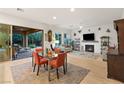 Bright living room with fireplace, modern decor, and access to outdoor patio at 9889 Gemstone Sunset Ave, Las Vegas, NV 89148