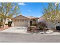 Charming single-story home with a well-manicured front yard and a two-car garage at 10540 Beachwalk Pl, Las Vegas, NV 89144