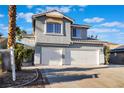 Two-story home showcasing a spacious driveway with a two-car garage and desert-friendly landscaping at 108 Appian Way, Henderson, NV 89002