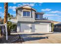 Two-story home showcasing a spacious driveway with a two-car garage and desert-friendly landscaping at 108 Appian Way, Henderson, NV 89002