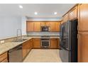 Modern kitchen with granite countertops, stainless steel appliances, and stylish wood cabinets at 11408 Newton Commons Dr # 104, Las Vegas, NV 89135